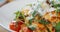 Pouring the cooked pasta with olive oil, delicious italian dish close-up.