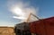 Pouring corn grain into tractor trailer after harvest