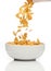 Pouring cornflakes into a bowl,