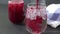 Pouring cranberry juice into sparkling mineral water slow motion