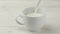 Pouring cup milk closeup