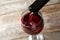 Pouring delicious red wine into glass