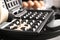 Pouring dough onto Belgian waffle maker, closeup