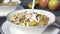 Pouring fresh milk over a bowl of muesli