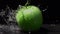 Pouring fresh water on a green apple on black background