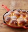 Pouring glasse sugar in brioche ball pie in a pan