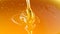 Pouring golden honey texture. Healthy and natural delicious sweets. Flow dripping yellow melted liquid. Food background