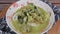 Pouring Green curry chicken on Thai Rice Noodles Rice Vermicelli Noodles, Kanom Jeen