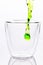 Pouring green water in to clear glass