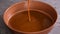 Pouring homemade caramel into pan.