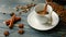 Pouring homemade coffee into a cup. Coffee beans, cinnamon sticks and a crumb on a wooden table.