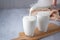 Pouring homemade kefir, buttermilk or yogurt with probiotics.