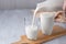 Pouring homemade kefir, buttermilk or yogurt with probiotics. Copy space