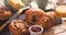 Pouring honey over a French breakfast with pastries and orange juice