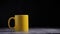 Pouring the hote steam water to a yellow mug for hot coffee with smoke over a black background