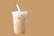 Pouring milk  and Iced or frappe coffee cup on glass cup isolated  brown background