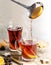 Pouring mulled wine in glass mugs, Christmas cookies and spices