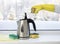 Pouring natural destilled acid white vinegar in electric kettle to remove boil away the limescale. .