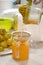 Pouring orange juice from a juicer into a glass jar.