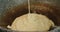 Pouring pancake batter into rustic old pan.