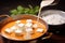 pouring paneer butter masala over fluffy basmati rice