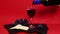 Pouring red wine into a glass. Rose wine with cheese and grapes. Red Wine from Bottle on Luxury Red Background.