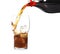 Pouring refreshing cola into glass with ice cubes on white