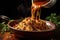 pouring sauce over freshly cooked pasta in a bowl