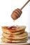 Pouring a stack of oatmeal with strawberry jam with a spindle