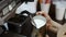 Pouring stream milk, barista prepares latte with steam, coffee machine