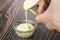 Pouring sweet condensed milk from metallic jar in bowl