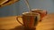 Pouring tea into a tea cup. Person pours tea into a beautiful vintage tea cup