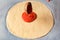 Pouring tomato sauce on pizza base