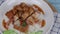 Pouring on Top of Rice crispy pork in a white plate , Thai famous street food