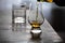 Pouring in tulip-shaped tasting glass Scotch single malt or blended whisky