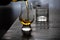 Pouring in tulip-shaped tasting glass Scotch single malt or blended whisky