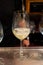 Pouring of txakoli or chacolà­ slightly sparkling very dry white wine produced in Spanish Basque Country in pinchos bar in old