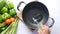 Pouring vegetable oil into frying pan.