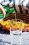 Pouring water from green bottle into a glass. Fried potatoes dish in the background