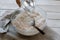 Pouring water over flour in a bowl for making bread