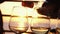 Pouring white wine in four glasses at amazing sunset by the sea in beach cafe before partying in slow motion. 3840x2160