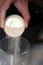 Pouring yeast grains into a clear glass.