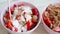 Pouring yogurt into bowl full of cutted strawberry and flakes