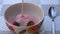 Pouring yogurt into the bowl of strawberries