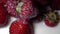 Pouring yogurt onto strawberries in slow motion
