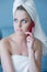 Pouting Woman in Bath Towel with Red Cell Phone