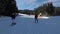 POV beginner girl on skis and amateur skiers slide down on ski slope at ski resort