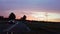 POV Car driving on the state road, colorful sky with orange, red and blue