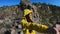 POV, carefree couple high fives standing on top of mountain