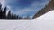 POV downhill skiing on ski slope at a ski resort. People skiing on a slope